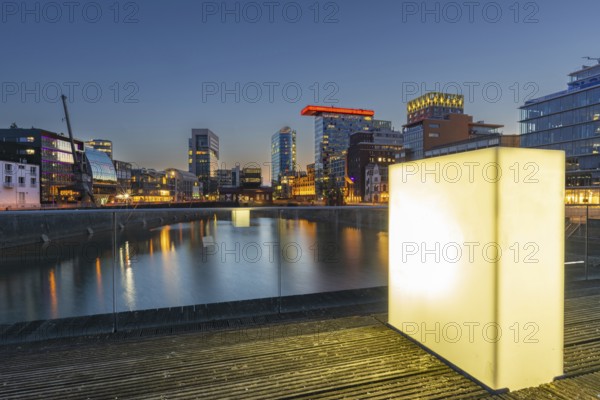 Illuminated pedestrian bridge over the harbour basin in the Media Harbour, Düsseldorf, North Rhine-Westphalia, Germany, Europe