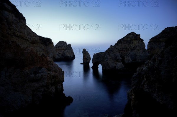Blue hour in front of sunrise, rocks in the sea, Ponta da Piedade, Lagos, caves, cliffs, Atlantic Ocean, Algarve, Portugal, Europe