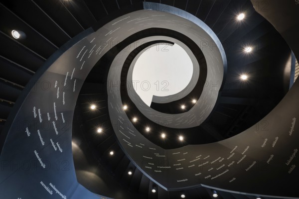 Spiral staircase printed with Finnish words, Oodi Central Library and Cultural Centre, designed by ALA Architects, Helsinki, Finland, Europe