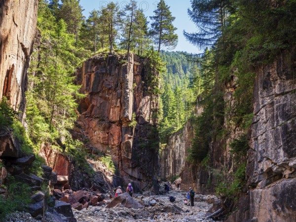 GEOPARC Bletterbach canyon, layers of sediments, stratum, people hike inside the gorge, Aldein, south Tyrolia, Italy, Europe