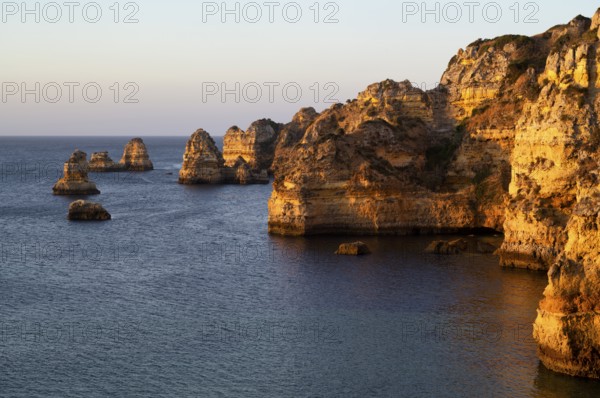 Colourful cliffs and rocks at sunrise on the beach, Praia da Dona Ana, Lagos, cliffs, Atlantic Ocean, Algarve, Portugal, Europe