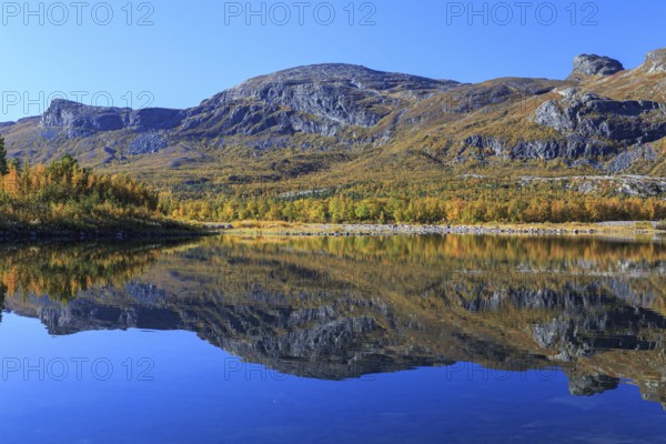 Mountains reflected in lake, autumn colours, sunny, bright, Stora Sjöfallet National Park, Laponia, Lapland, Sweden, Europe