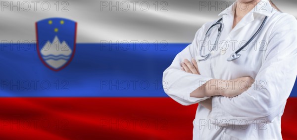 Doctor with crossed arms on slovenian flag, slovenia health and care concept, female doctor on slovenian flag