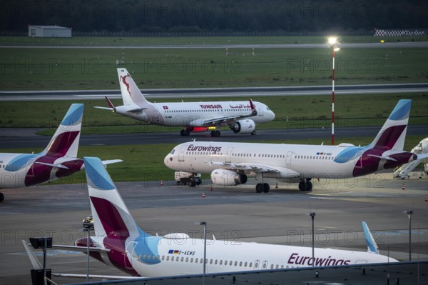 Düsseldorf Airport, Eurowings aircraft, in parking position, Tunisair on the taxiway for take-off