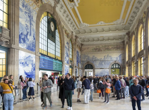 Tour groups viewing historic azulejos tiles, Sao Bento railway station building, city of Porto, Portugal, Europe