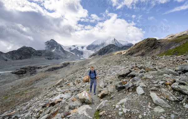 Mountaineer on a hiking trail, behind glacier Glacier de Cheilon and summit Mont Blanc de Cheilon, Valais Alps, Valais, Switzerland, Europe