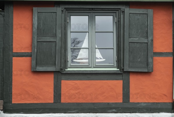 Window with sail boat in red half-timbered house in Ystad's historic city center, Skåne County, Sweden, Scandinavia, Europe
