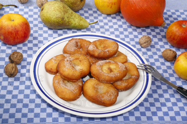 Swabian cuisine, harvest cakes, dessert, dessert, fat baked goods, doughnuts, fried food, lard noodles, arranged on a plate, grandmother's kitchen, regional, home cooking, typical Swabian, classic recipe, traditional cuisine, food photography, autumn atmosphere, apples, pears, nuts, still life, studio, Germany, Europe