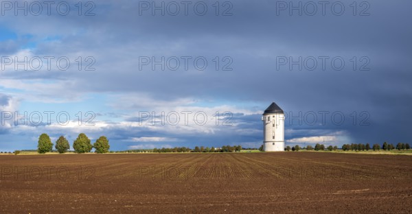 Water tower Crölpa-Löbschütz, field landscape with ploughed field under a stormy sky with dramatic clouds, near Naumburg, Saxony-Anhalt, Germany, Europe