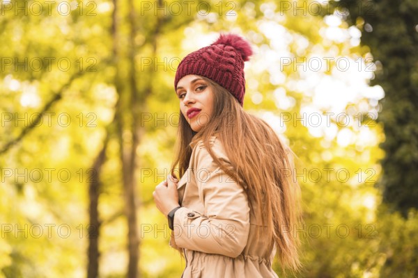 Portrait of woman in autumn next to a forest in nature