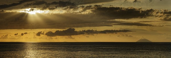 Sunset on the beach of Tropea with the Aeolian (Liparic) Islands and the volcanic island of Stromboli on the horizon, Tropea, Vibo Valentia, Calabria, Southern Italy, Italy, Europe
