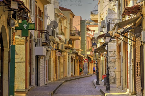Venetian old town, old town alley almost deserted, colourful houses, cobbled alleyway, morning light, Rethimnon, central Crete, island of Crete, Greece, Europe