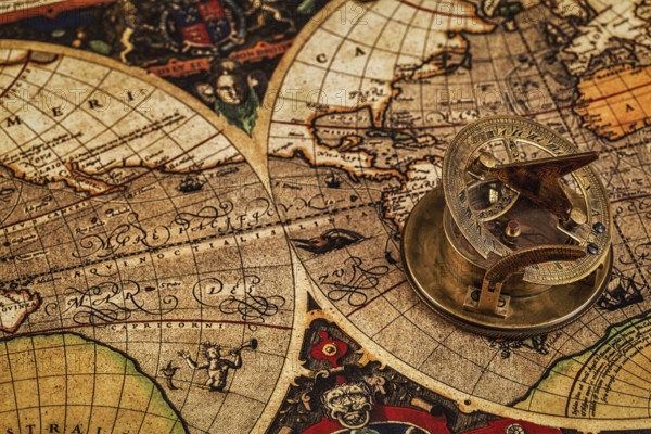 Travel geography navigation concept background, old vintage retro compass with sundial on ancient world map