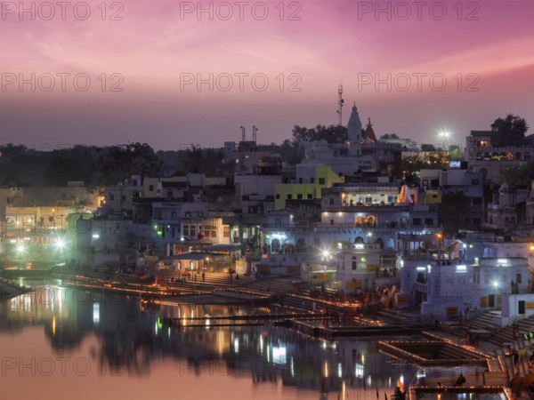 Sacred Puskhar lake (Sagar) and ghats of town Pushkar in twilight in the evening, Rajasthan, India, Asia