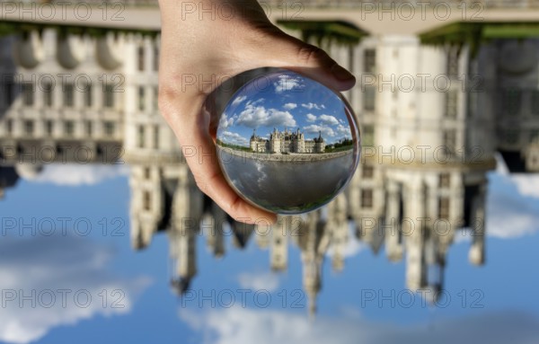 View of the Chateau de Chambord through a transparent ball. Loir-et-Cher department, Centre-Val de Loire, France, Europe