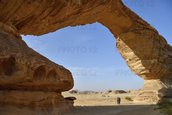 Tourists at The Arch, also known as Rainbow Rock, near AlUla, Medina Province, Saudi Arabia, Arabian Peninsula, Asia