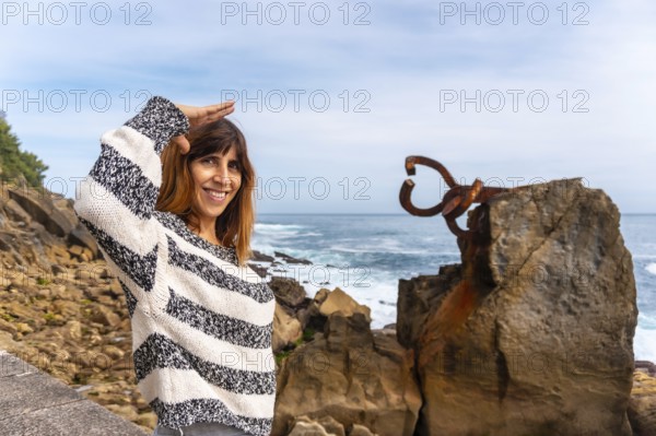 A young European tourist visiting the Peine del Viento in San Sebastián. Province of Gipuzkoa, Basque Country. Spain