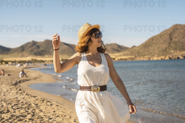 Woman enjoying alone walking along a beach in Cabo de Gata, Spain, Europe