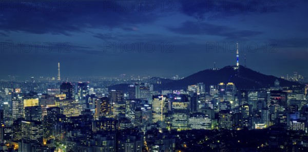 Panorama of Seoul downtown cityscape illuminated with lights and Namsan Seoul Tower in the evening view from Inwang mountain. Seoul, South Korea, Asia