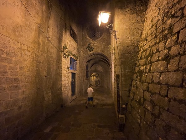 Boy in an alley in the old town of Kotor, historical, night, eerie, Bay of Kotor, Adriatic Sea, Mediterranean Sea, World Natural and Cultural Heritage, Kotor, Montenegro, Europe