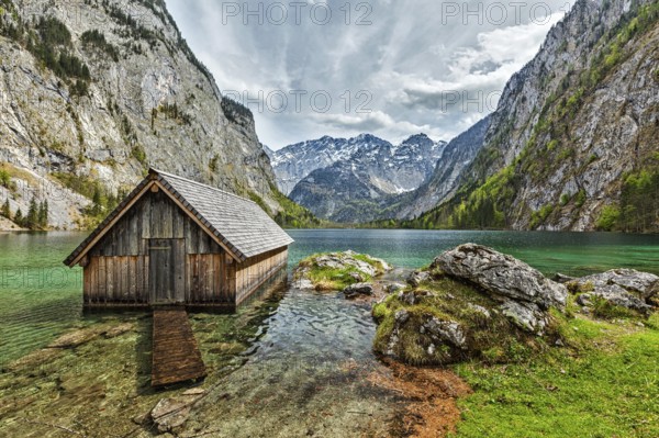 Boat dock hangar on Obersee mountain lake in Alps. Bavaria, Germany, Europe