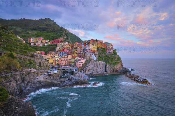 Manarola village popular european italian tourist destination in Cinque Terre National Park UNESCO World Heritage Site, Liguria, Italy on sunset