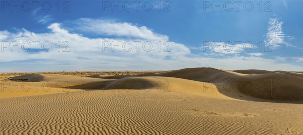 Panorama of dunes landscape with dramatic clouds in Thar Desert. Sam Sand dunes, Rajasthan, India, Asia