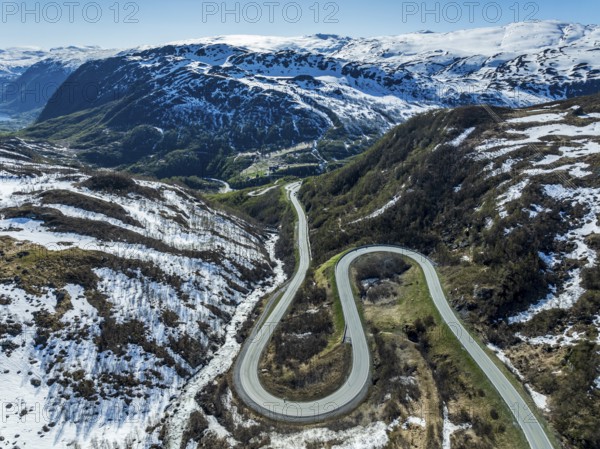 Aerial view of mountain road over the Haukelifjell, winding down to Roeldal, early spring, Norway, Europe