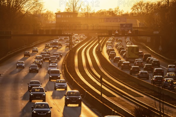 Motorway A40, dense, slow-moving traffic jam, evening traffic at the Essen-Kray junction, low sun, public transport bus lane in the middle of the motorway, North Rhine-Westphalia, Germany, Europe