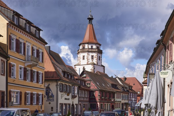 Historic tower Niggelturm and houses on the main street in rainy weather in Gengenbach, Black Forest, Ortenaukreis, Baden-Württemberg, Germany, Europe