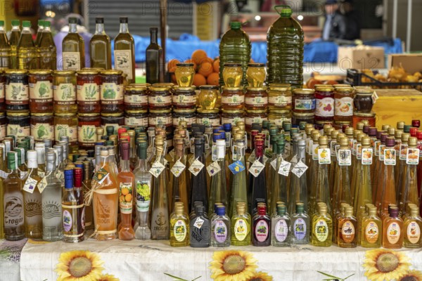 Liqueurs, schnapps, honey and olive oil at the market in Trogir, Croatia, Europe