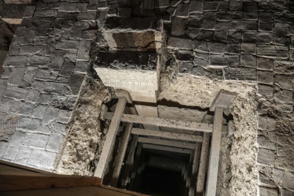 Wooden support structures inside a crumbling medieval stone passage at the royal palace of olite, navarre, spain, embodying history
