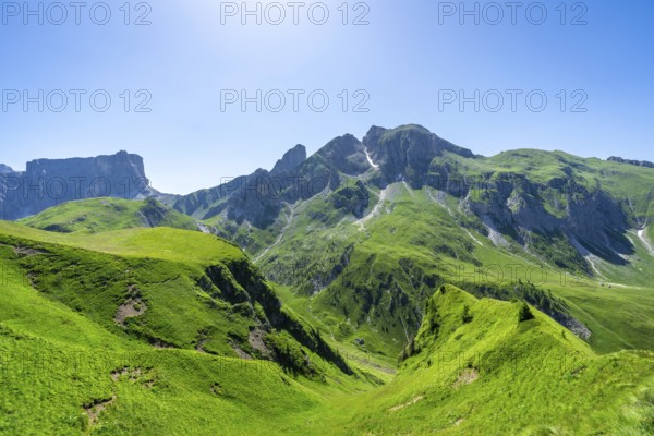 Breathtaking view of the lush green slopes and rugged peaks of passo giau in the italian dolomites during summer