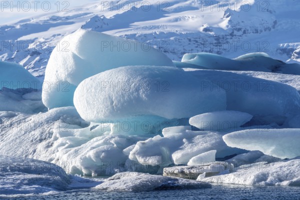 A large block of ice is surrounded by smaller pieces of ice, Jokulsarlon, Iceland, Europe