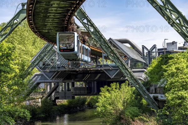 The Wuppertal suspension railway, train of the latest generation 15, floats above the Wupper, Wuppertal-Ohligsmühle station, North Rhine-Westphalia, Germany, Europe