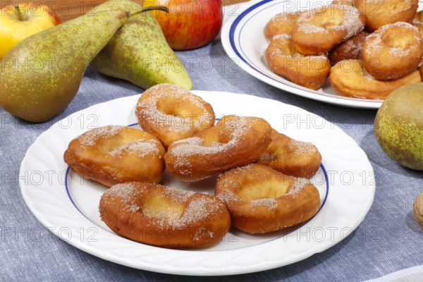 Swabian cuisine, harvest cakes, dessert, dessert, fat baked goods, doughnuts, fried food, lard noodles, arranged on a plate, grandmother's kitchen, regional, home cooking, typical Swabian, classic recipe, traditional cuisine, food photography, autumn atmosphere, apples, pears, nuts, still life, studio, Germany, Europe