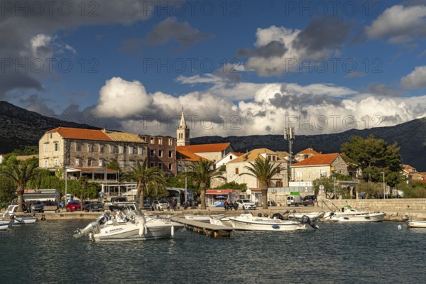 Town view with harbour and church Crkva Marija Pomocnica in Orebic, Peljesac peninsula, Croatia, Europe