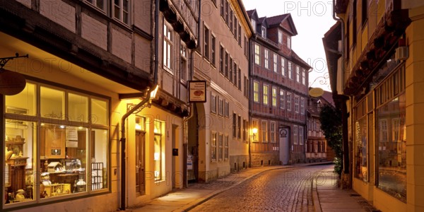 Half-timbered houses in a narrow street with cobblestones, Old Town in the evening, World Heritage City of Quedlinburg, Saxony-Anhalt, Germany, Europe