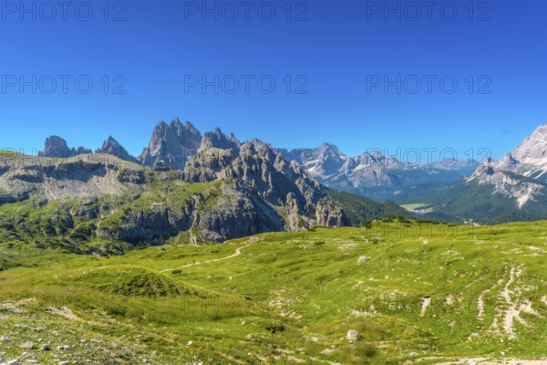 Breathtaking landscape of tre cime di lavaredo peaks towering above lush green meadows in the italian dolomites, a unesco world heritage site. Summer holidays in the Italian Dolimites. Italy