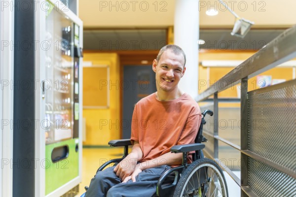 Caucasian smiling man with cerebral palsy next to a vending machine in a modern coworking