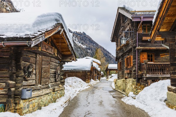 Street with historic old snow-covered wooden houses, mountain village of Zinal, Val d'Anniviers, Valais Alps, Canton Valais, Switzerland, Europe