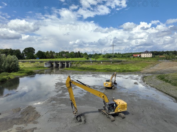 Dortmund / Castrop-Rauxel, North Rhine-Westphalia, Germany, river renaturalisation, renaturation of the Emscher, flood retention basin HRB Mengede. A new floodplain landscape is being created at the Emscher-Auen farm, expanding the area for flood protection during heavy rainfall and for biodiversity. The Emscher, which is currently straightened, will be given curves again and can meander through its new floodplain. Following the construction of a parallel sewer, the Emscher has been completely free of wastewater since 2022. The river was previously an open, above-ground mixed water channel with rainwater and wastewater. At the back right, the Uniper coal-fired power plant Datteln 4 power station, Europe