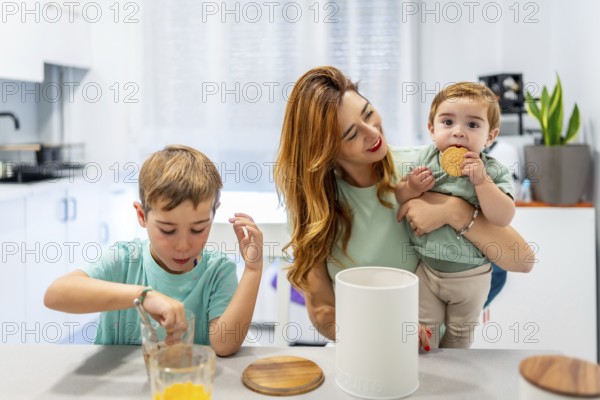 Schoolboy enjoying breakfast with his family at home dipping the cookies in the milk