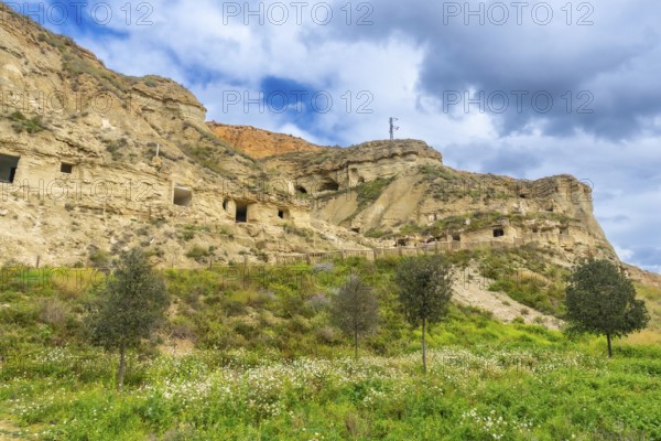 Scenic view of cuevas de arguedas, ancient cave dwellings carved into sandstone cliffs, highlighting unique troglodyte architecture in navarre