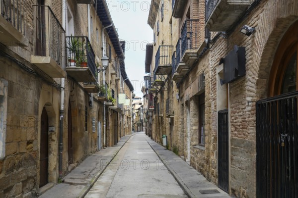 Empty narrow street with balconies and medieval buildings in the historic town of olite, navarre, spain