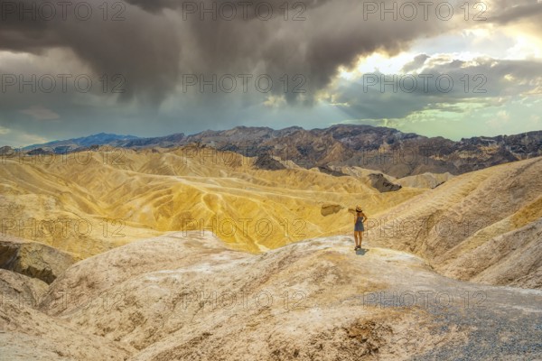 A young woman in dress enjoying the view of the viewpoint of Zabriskie Point, California. United States