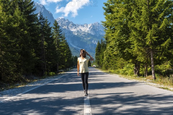Young tourist walking on the road in Valbona valley, Theth national park, Albanian Alps, Valbona Albania