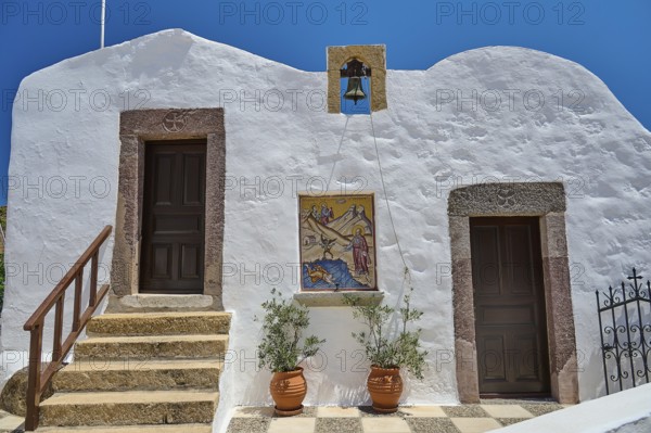 Traditional Greek building with white wall, two doors, bell and staircase under blue sky, Baptistery, St John the Theologian, Skala, Patmos, Dodecanese, Greek Islands, Greece, Europe