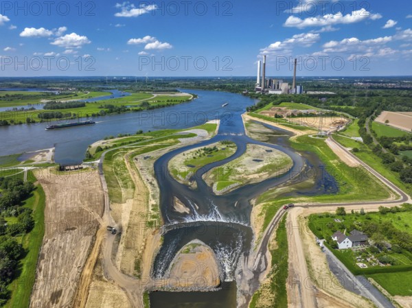 Dinslaken, Voerde, North Rhine-Westphalia, Germany, Renaturalisation of the Emscher. New Emscher estuary into the Rhine. Flood protection through land expansion. The decommissioned STEAG coal-fired power station in Voerde in the background. The mouth of the Emscher into the Rhine was moved from Dinslaken to Voerde, almost 500 metres to the north. Fish can now swim barrier-free up the new Emscher from the Rhine through a newly created floodplain area. Following the construction of a parallel sewer, the Emscher has been completely free of sewage since January 2022. The river was previously an open, above-ground combined sewer with rainwater and wastewater, Europe