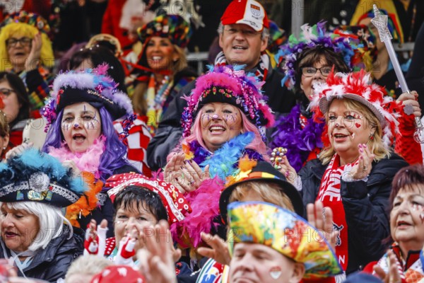 Colourfully costumed carnivalists celebrate carnival in Cologne, on Weiberfastnacht the street carnival is traditionally opened on the Alter Markt, which then reaches its climax on Rosenmontag, Cologne, Rhineland, North Rhine-Westphalia, Germany, Europe